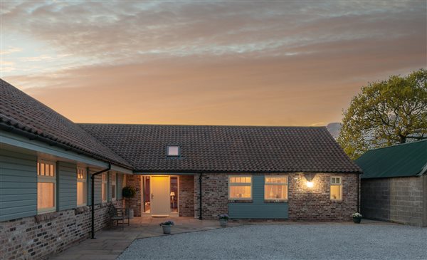 holiday cottage lit up at dusk